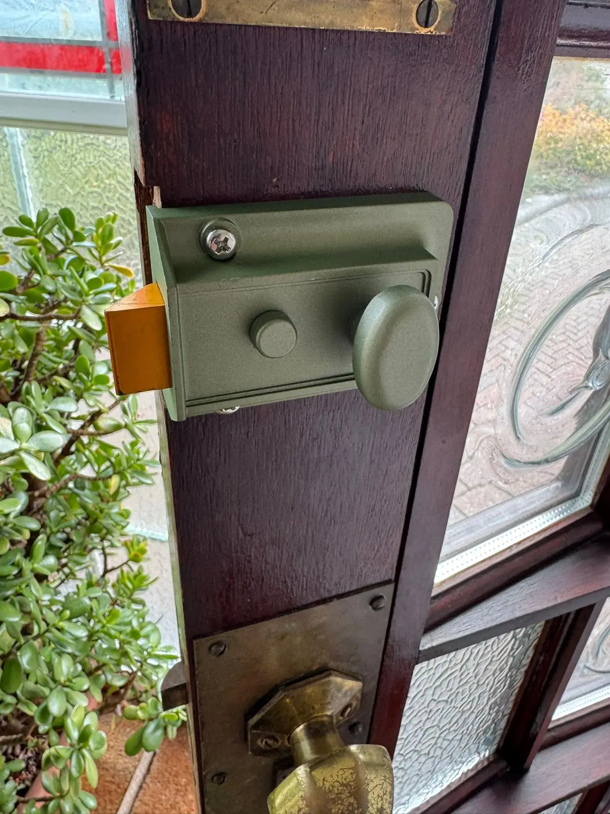 Locksmith repairing a damaged door lock after a break-in