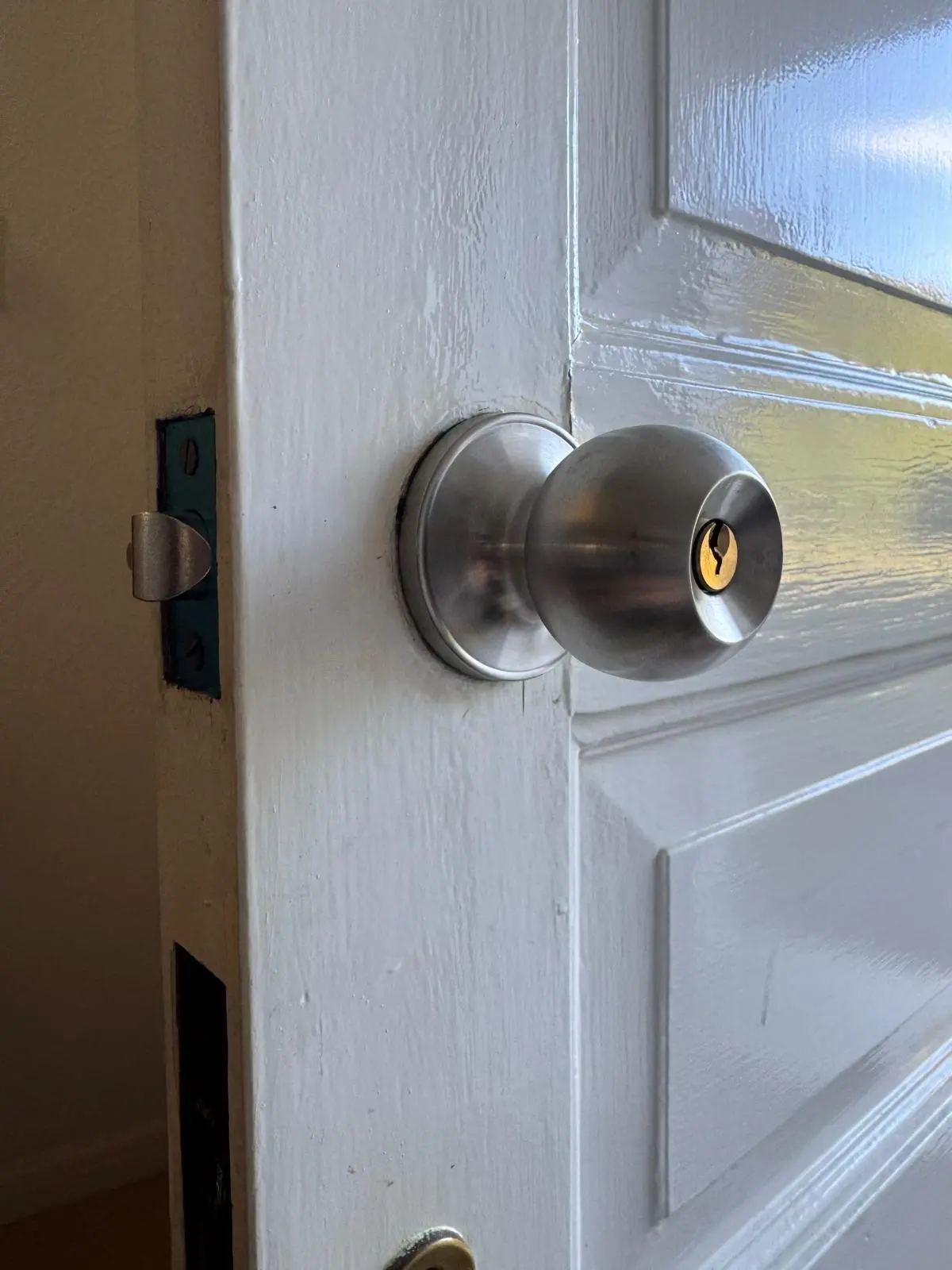 Locksmith fitting a door knob lock to a residential door