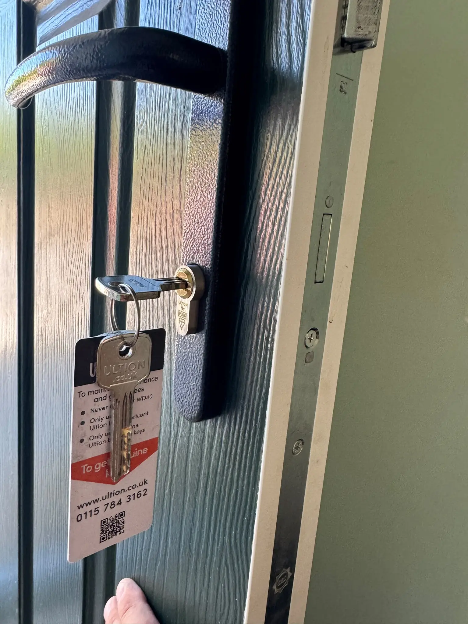 Locksmith fitting a new lock to a residential door