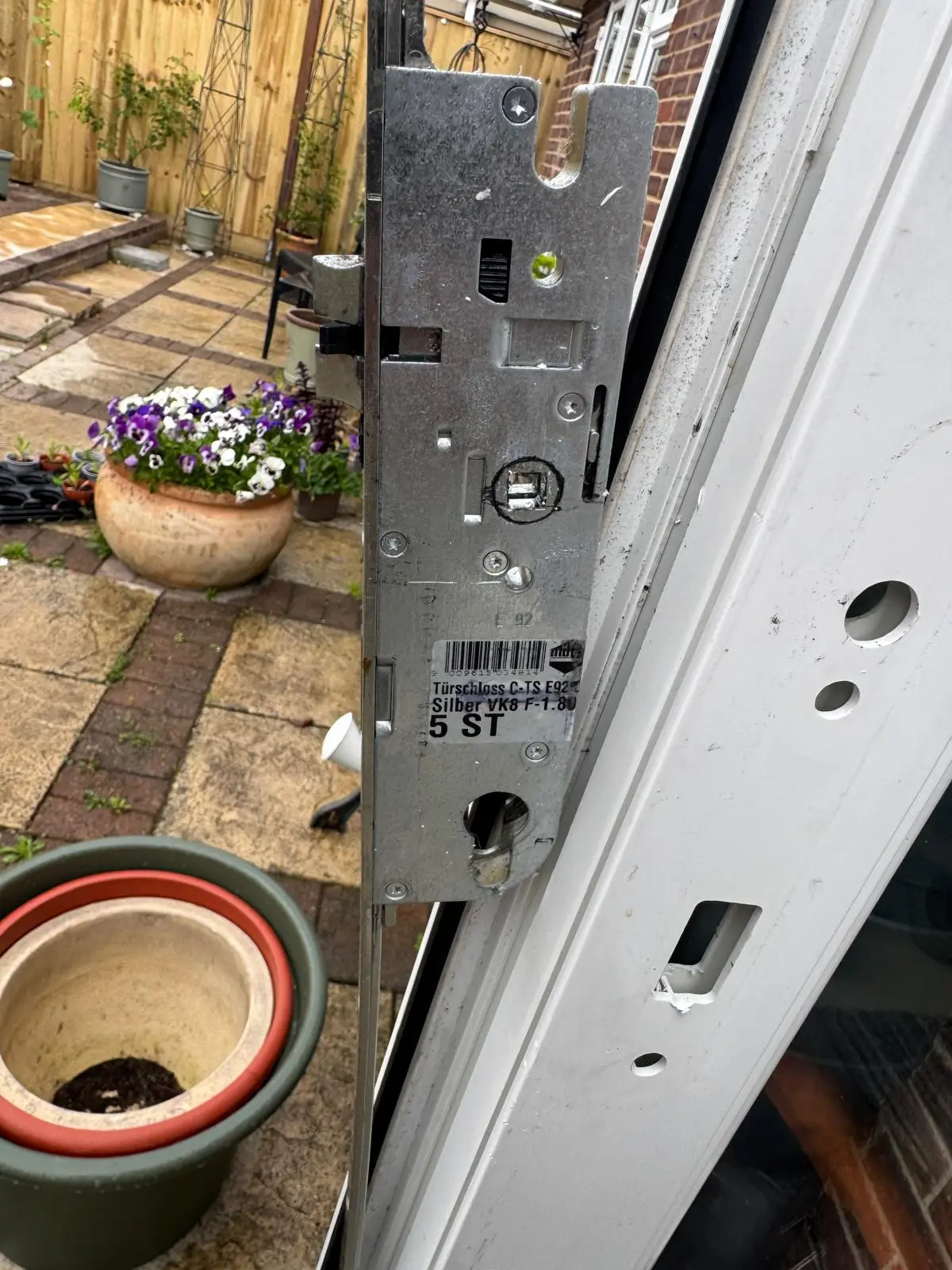 Locksmith replacing a uPVC door lock mechanism